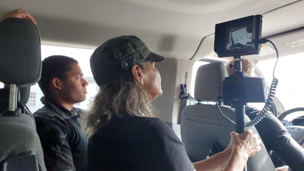 Tammy Thompson filming Word and Deed in a van