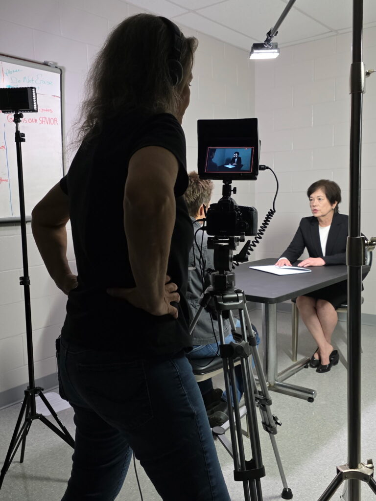 Tammy Thompson on set monitor filming Word and Deed